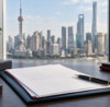 Company formation documents and pen overlooking Shanghai skyline